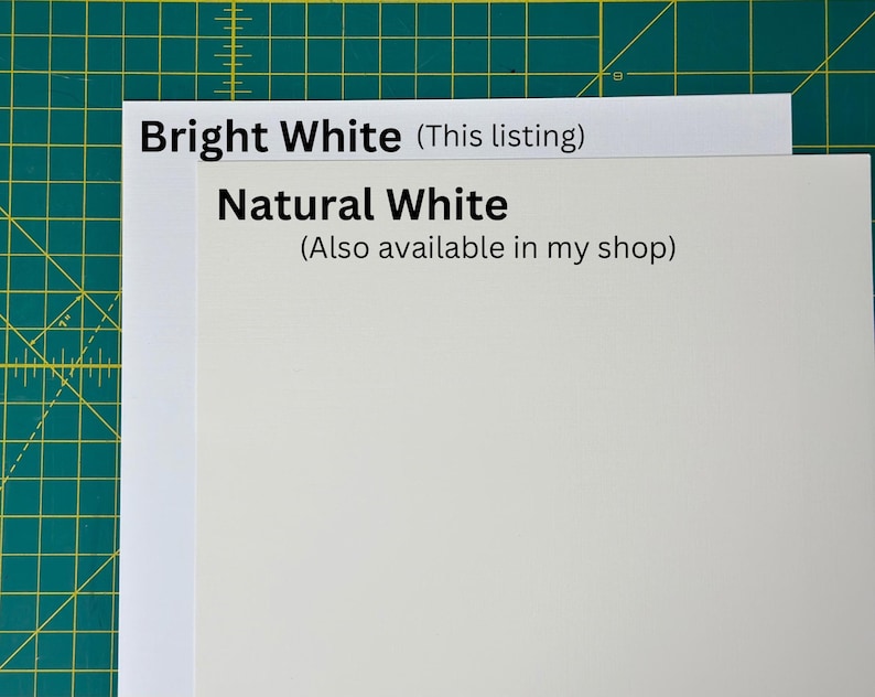 May include: Two pieces of white paper, one labelled "Bright White (This listing)" and the other labelled "Natural White (Also available in my shop)".