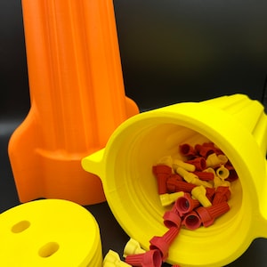 May include: Two yellow and orange plastic containers with a lid. The containers are filled with red and yellow wire connectors.