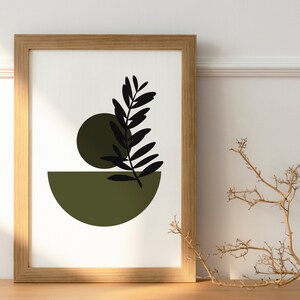 May include: A framed print with a minimalist design featuring a black silhouette of a leaf and two green circles on a white background.