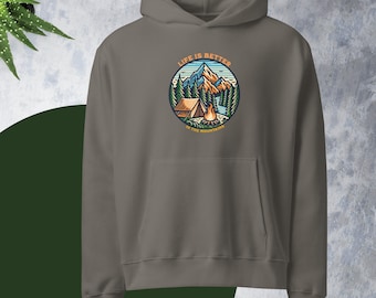 May include: A gray hoodie with a front pocket and a hood. The hoodie features a circular graphic with the text "LIFE IS BETTER IN THE MOUNTAINS." The graphic depicts a mountain scene with a tent, campfire, and trees.