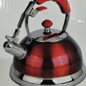 May include: A red and silver tea kettle with a curved red handle and a silver spout. The kettle has a shiny, reflective surface and a silver base. The handle and lid knob are also red.