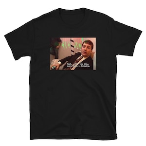 May include: A black t-shirt with a white image of a man in a suit and tie. The man is looking at the camera and saying "Yeah, well, you know, everything's decaying."