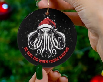 Cthulhu Christmas Ornament with Cthulhu in a Santa Hat, Promising that He Sees You When You're Sleeping! A darkly festive ceramic ornament.