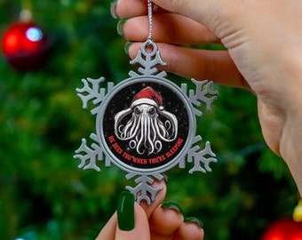 Funny Cthulhu Christmas Ornament with Cthulhu in a Santa Hat, 'He Sees you When You're Sleeping' on a Snowflake-Shaped Pewter Ornament.