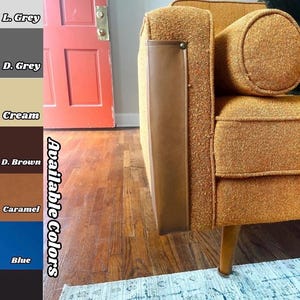 May include: Close-up of a mid-century modern style sofa in a textured orange fabric. The sofa has a brown leather armrest detail and wooden legs. The image also shows a color palette with available colors: L. Grey, D. Grey, Cream, D. Brown, Caramel, Blue, and Black.