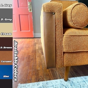 May include: Close-up of a mid-century modern style sofa in a textured orange fabric. The sofa has a brown leather armrest detail and wooden legs. The image also shows a color palette with available colors: L. Grey, D. Grey, Cream, D. Brown, Caramel, Blue, and Black.