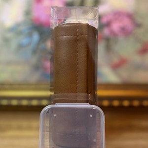 May include: A kit containing a brown vinyl corner cover and six decorative tacks, packaged in a clear plastic container. The text on the image reads "Kit Includes One Vinyl Corner Cover And Six Decorative Tacks" and "*2 Pack Listed Separately*".