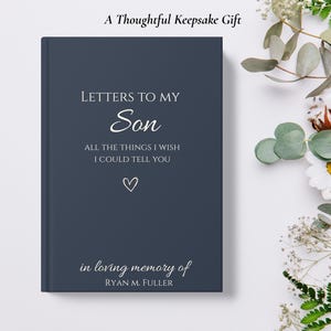 Op de afbeelding: Een marineblauw boek met de titel "Letters to My Son" met de tekst "All the things I wish I could tell you" en "in loving memory of Ryan M. Fuller". Het boek heeft een hartsymbool en de woorden "A Thoughtful Keepsake Gift" bovenaan.