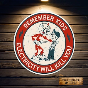 May include: A circular metal sign featuring a vintage-style cartoon illustration of a red lightning bolt character holding a knife toward a young person. The text REMEMBER KIDS ELECTRICITY WILL KILL YOU is printed in white on a red border.