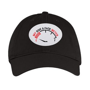 May include: Black baseball cap with a white patch that reads "My Give A F*ck Meter" with a red needle pointing to "F".
