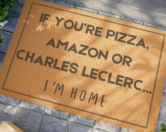 May include: A brown doormat with the text "If you're pizza, Amazon or Charles Leclerc... I'm home" printed in black.