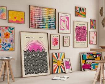 May include: A collection of framed art prints in various sizes and styles, including abstract, floral, and geometric designs. The color palette includes pink, yellow, blue, and green. Some prints feature text, such as "Bauhaus 1919" and "Matisse."