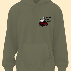 A green hoodie with a graphic of a cartoon goose and the text "Honk Honk Hoe" printed on it.