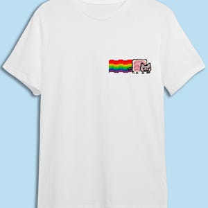 A white t-shirt with a colorful graphic design on the front, depicting a cat and a rainbow.