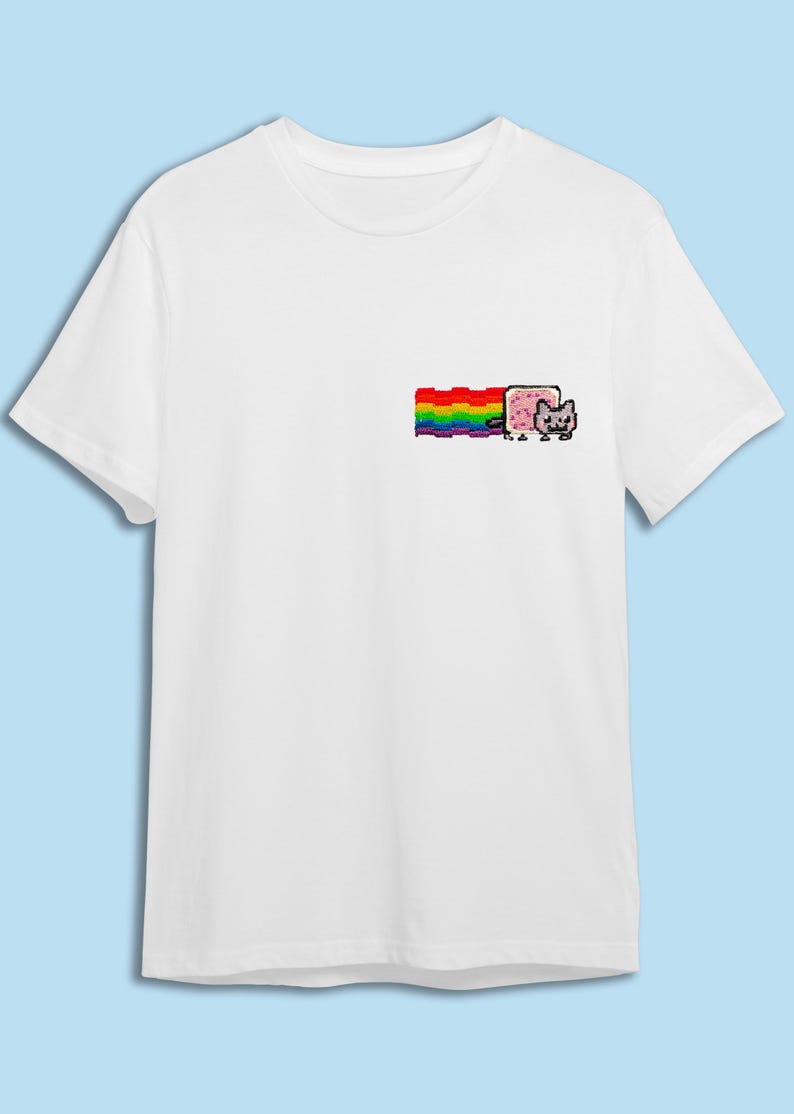 A white t-shirt with a colorful graphic design on the front, depicting a cat and a rainbow.