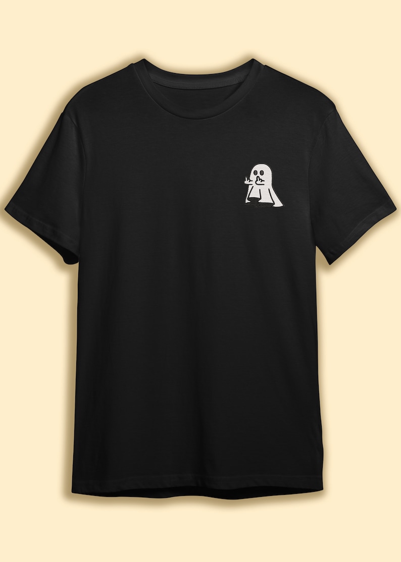 May include: A black t-shirt with a white ghost design. The ghost is making a rude gesture with its hand.
