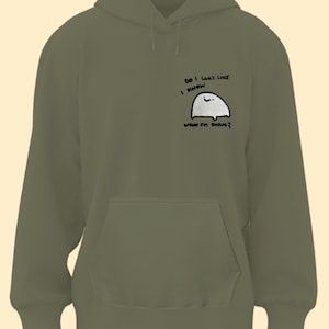 A green hoodie with a small cartoon character on the front pocket.