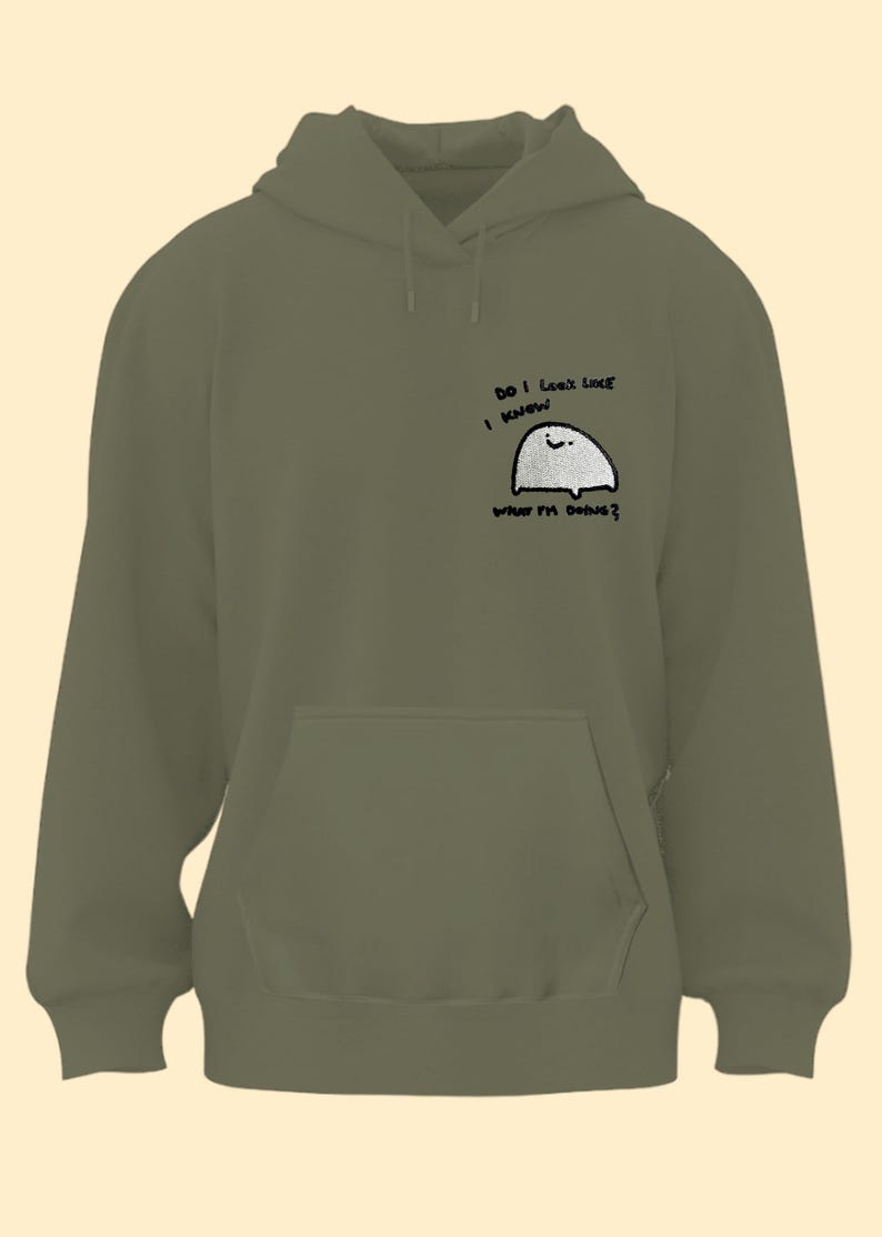 A green hoodie with a small cartoon character on the front pocket.