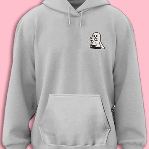 May include: A gray hooded sweatshirt with a small black and white ghost graphic on the left chest. The ghost is giving a middle finger.