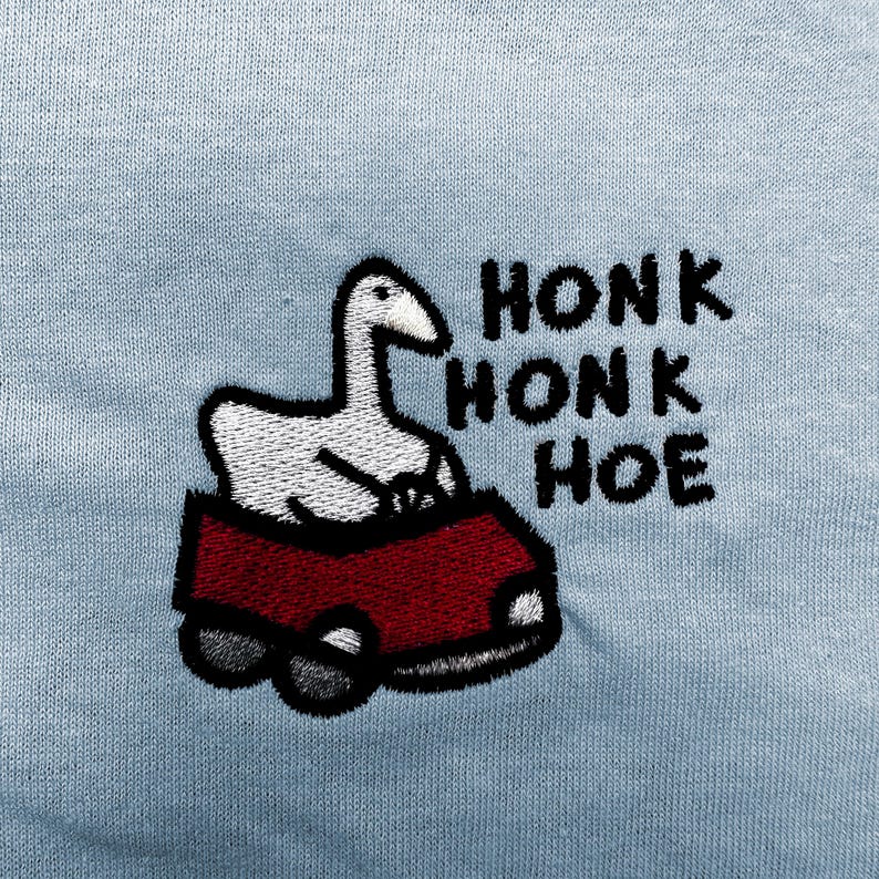 a cartoon goose riding in a red car, with the text "HONK HONK HOE" written above it.