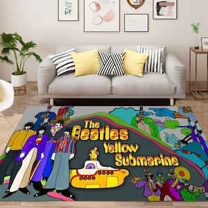 May include: A colorful rug featuring the Beatles' Yellow Submarine album cover art. The rug depicts the band members, the submarine, and other characters from the film. The text "The Beatles Yellow Submarine" is prominently displayed on the rug.