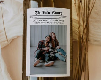 May include: A white wine bottle with a custom label that reads "The Love Times" with the text "Kylie & Todd" and "2024-Forever". The label also includes a photo of a couple laughing and the text "Of all the weird things I've found online, you're by far my favorite."