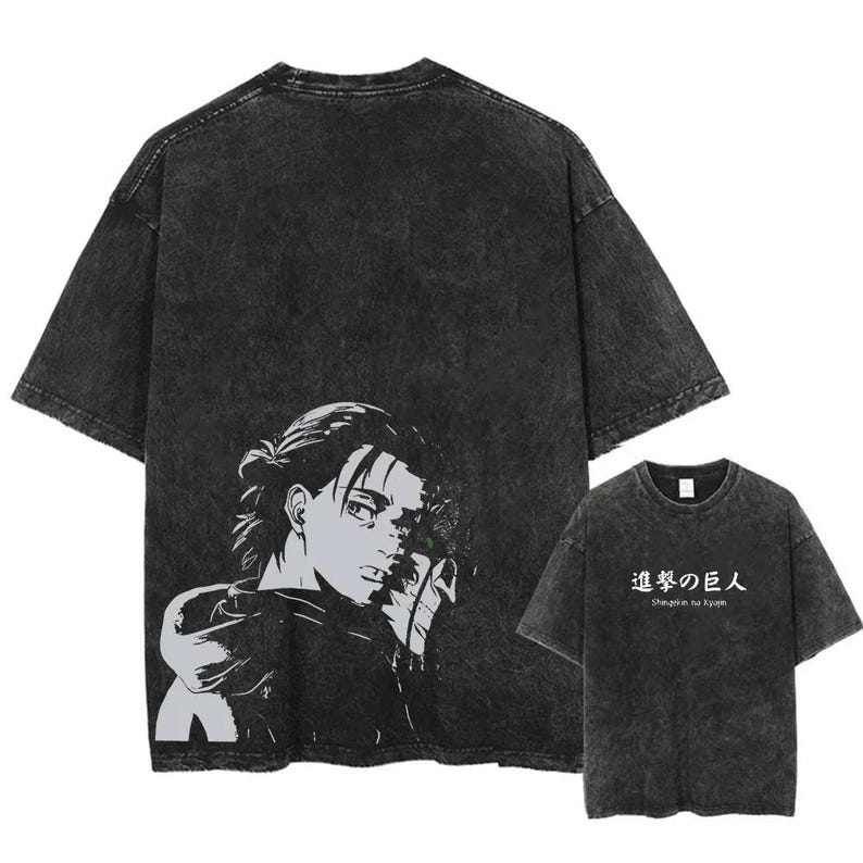 May include: Dark gray t-shirt featuring a black and white graphic of a character from the anime series, Attack on Titan. The shirt has a vintage, washed look. The text "Shingeki no Kyojin" is printed on a smaller shirt.
