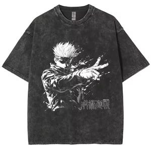 May include: Dark gray t-shirt featuring a white and black graphic of an anime character with white hair and sunglasses. The character is pointing with one hand, and Japanese text is below the image. The shirt has a vintage, washed look.