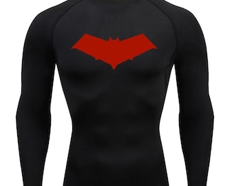 May include: Black long-sleeved shirt with a red bat logo on the chest. The shirt is made of a compression fabric.