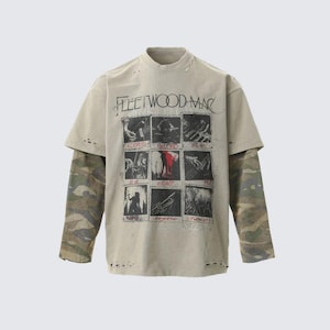 May include: Beige, distressed-look t-shirt with a mock neck and long camouflage sleeves. The front features a graphic with the text "FLEETWOOD MAC" and a series of black and white images. A vintage-inspired music tee.