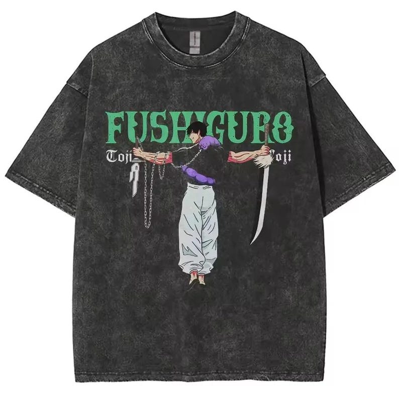 May include: Dark gray t-shirt with a graphic of a character from an anime series. The character is depicted with a sword and chains, and the shirt features the name "Fushiguro" in green lettering. The shirt has a vintage, worn look.