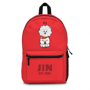 May include: Red backpack with a white cartoon dog wearing a red bandana and the text "RJ" above it. The backpack also has the text "JIN EST. 1992" on the front.