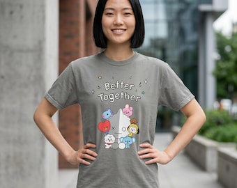 May include: A grey short-sleeved t-shirt featuring the text Better Together in white letters above a graphic of various colorful cartoon characters including a large white figure, a red heart, and small blue, pink, and yellow creatures.
