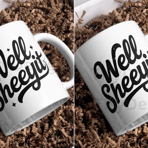 Two white mugs in packaging, each with “Well Sheeyit” design, one with sparkles and one distressed.