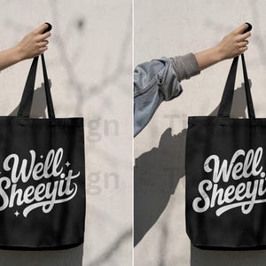 Two black tote bags held by a hand, each with “Well Sheeyit” design, one with sparkles and one distressed.