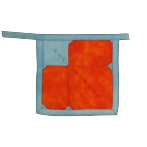 May include: A square quilted potholder featuring a bright orange center panel with a mottled texture, framed by a light blue fabric border. The design includes a matching light blue fabric loop extending from the top corner for hanging.
