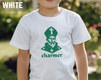 May include: White t-shirt with a green graphic of a man with a beard wearing a bishop's hat and the word "charmer" underneath.