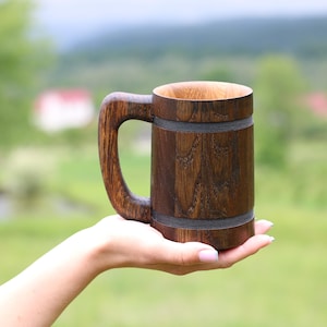 20 oz handcrafted wooden cup shown in hand for scale.
