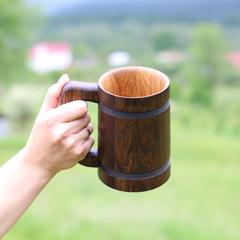 Eco-finished dark wood beer mug with rustic charm.