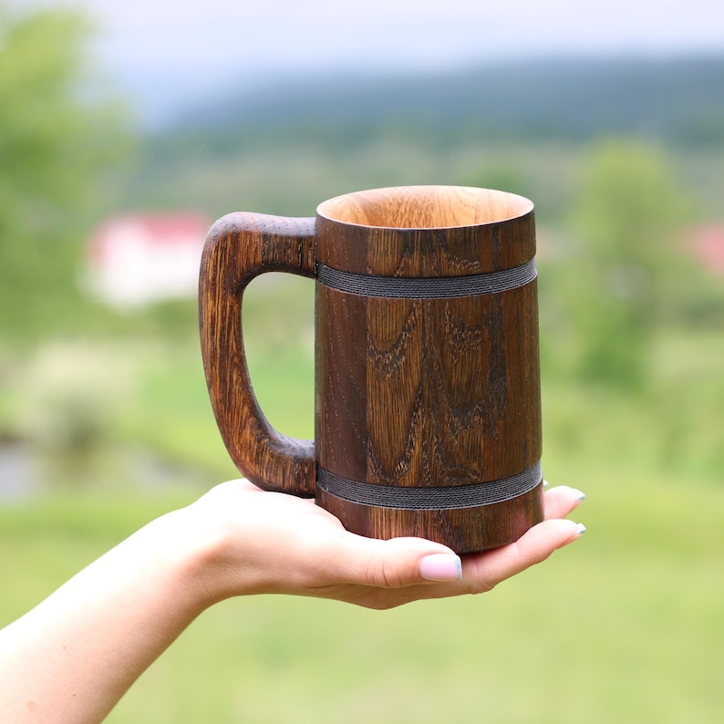 Oak beer mug in a natural green landscape background.