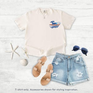 Folded shirt with small dachshund surfer pocket graphic on soft cotton fabric
