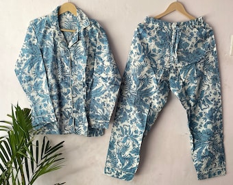 May include: A white pajama set with a blue floral print. The top has a collar and long sleeves. The pants have an elastic waistband.