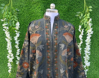 May include: A charcoal grey open-front jacket featuring a mandarin collar and long sleeves. The garment is decorated with intricate floral embroidery in shades of rust, beige, and sage green, covering the front panels and the sleeve cuffs.