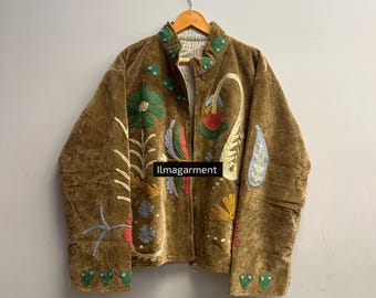 May include: A brown jacket with colorful floral embroidery. The jacket features a stand-up collar and is adorned with various embroidered flowers and leaf designs in green, red, blue, and yellow. The text "llmagarment" is visible on the jacket.