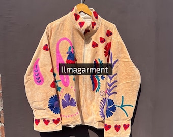 May include: Tan corduroy jacket with colorful embroidered floral and paisley designs. The jacket features a high collar, a full-length zipper, and red heart-shaped accents. The text "llmagarment" is visible.