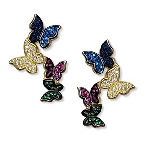 May include: A pair of earrings featuring five butterfly designs. Each butterfly is adorned with colourful cubic zirconia stones. The butterflies are arranged in a cascading pattern, with the largest butterfly at the top and the smallest at the bottom.