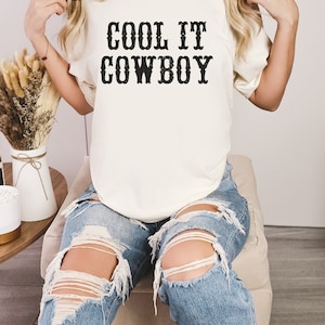 western theme cool it cowboy western lettering on a natural color shirt
