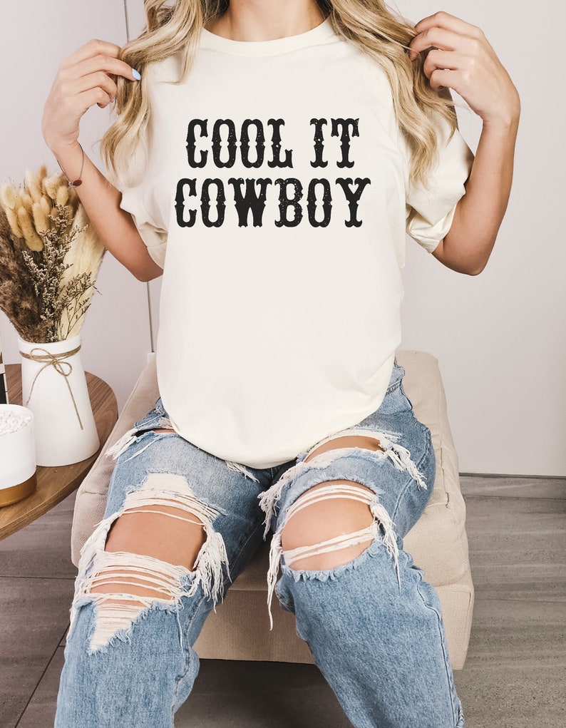 western theme cool it cowboy western lettering on a natural color shirt