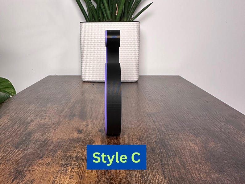 May include: A black and purple 3D printed letter C. The letter is standing on a wooden surface. The text "Style C" is visible below the letter.