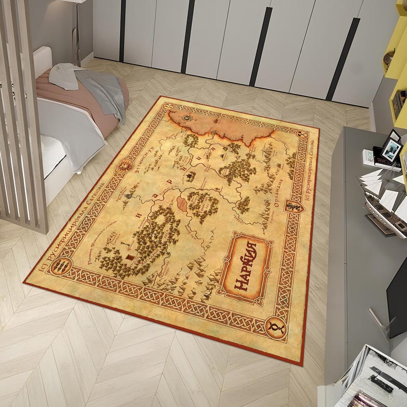 May include: A beige and brown area rug with a map of the fictional land of Narnia. The map is surrounded by a decorative border with Celtic knotwork. The text "Narnia" is written in red at the bottom of the map.